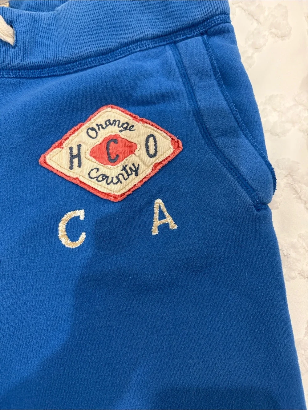 Holister draw waist fleece pants with 2 side pockets & 1 back pocket; blue